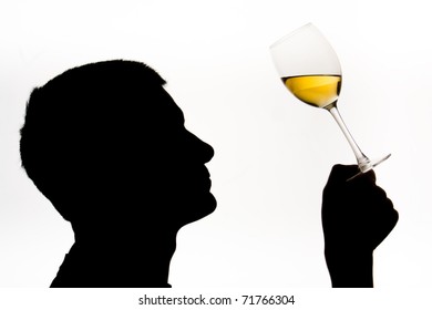 Wine expert testing wine with male in silhouette
