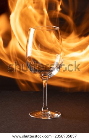 wine glass on a background of flames
