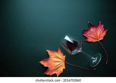 Wine glass with red wine and autumn grape leaves on black background. Creative wine degustation layout in rustic style, selective focus. Flat lay backdrop with copy space, top view. - Shutterstock ID 2016702860