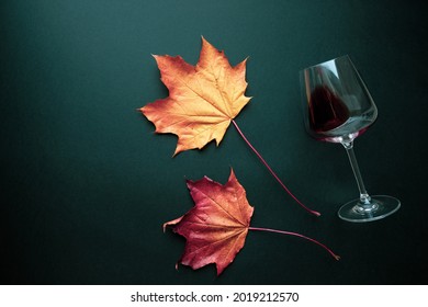 Wine glass with red wine and autumn grape leaves on black background. Creative wine degustation layout in rustic style, selective focus. Flat lay backdrop with copy space, top view. - Shutterstock ID 2019212570