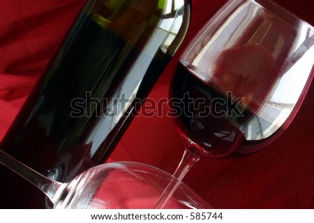 Wine glasses and bottle with red background