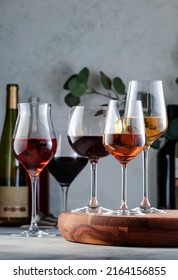 Wine glasses and bottles assortment. Red, white, rose wines on gray table background. Wine bar, shop, tasting concept - Shutterstock ID 2164156855