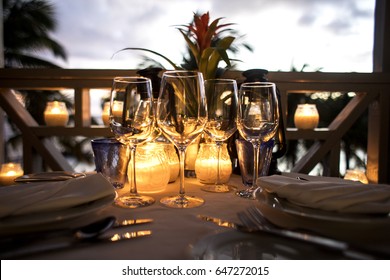 Wine Glasses and Candles set on the Table for Dinner - Shutterstock ID 647272015