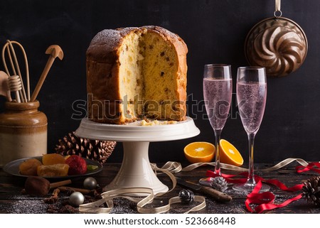 wine glasses and italian typical christmas cake called panettone on a table with christmas - Italian Christmas Table Decorations wine glasses and italian typical christmas cake called panettone on a table with christmas - Italian Christmas Table Decorations