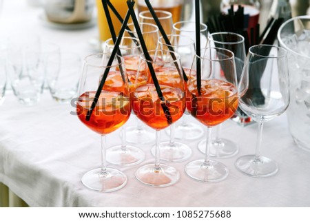 Wine glasses with red cocktails stand on the table