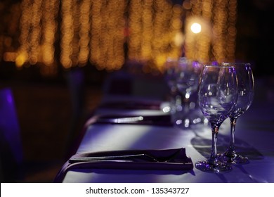 Wine glasses set on a dinner table at a wedding.