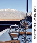 Wine glasses standing by the window overlooking the vineyard and Andes