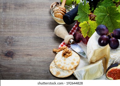 Wine, Grape And Cheese On Wooden Background