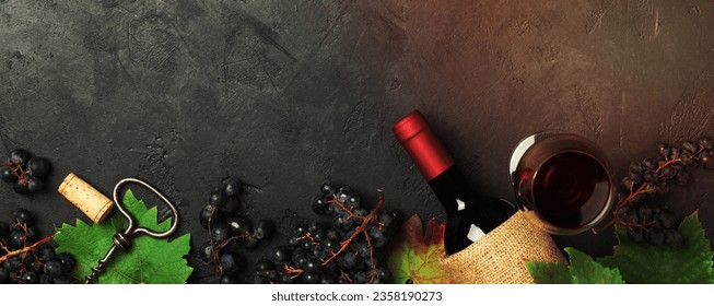 Wine with grapes, leaves and corks on dark background, copyspace, flat lay