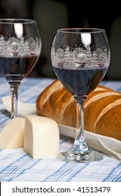 Wine In Holiday Glasses With French Bread And Cheese To Celebrate Christmas