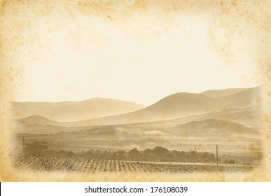 Wine Label For Your Design. Vintage Wine Poster At Old Paper Background. Ancient Framed Page With Vineyard And Mountain Landscape.