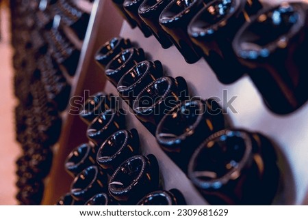 Wine making bottle resting for second fermentation Riddling Disgorging process in wine factory.