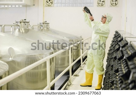 Wine making fermentation bottle Riddling or Disgorging process in wine factory.