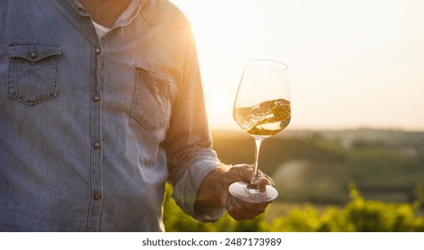 Wine producer mane tasting the product after harvest and grape fermentation process - Vinification, organic quality product and small business concept - Main focus on glass - Powered by Shutterstock