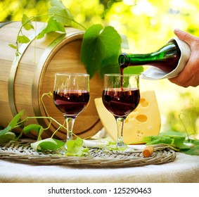 Wine. Red Wine and Cheese. Romantic Lunch Outdoor. Pouring Wine close-up. Outdoors - Powered by Shutterstock