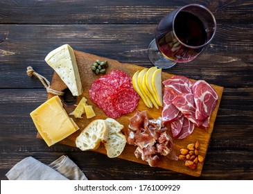 Wine snack. Prosciutto, Parma ham, salami, almonds, olives baguette blue cheese parmesan Antipasti - Powered by Shutterstock