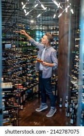 A Wine Store Owner Making A Revision And Looking Busy