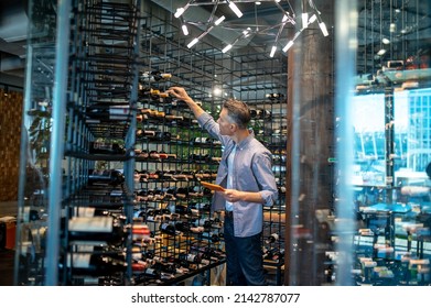 A Wine Store Owner Making A Revision And Looking Busy