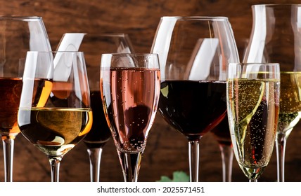 Wine tasting. Red, white, rose and champagne - still and sparkling wines sin glasses on vintage wooden table background - Powered by Shutterstock