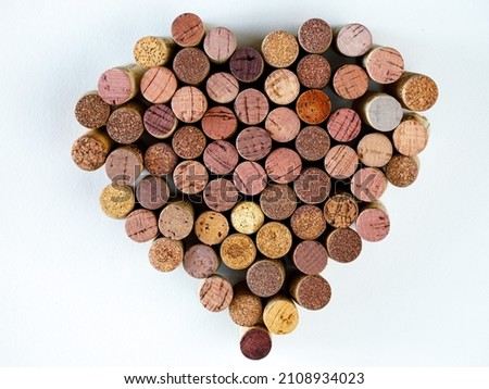 Wine used corks shape heart on a white background. Top view, copy space. High quality photo