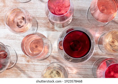 Wine Variety. White, Rose, And Red Wine In Many Glasses, Overhead Flat Lay Shot On A Wooden Background