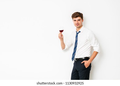 Wine Of Winners. Elegant Man Having A Glass Of Wine After A Long Office Day, Relaxing His Mind, On White Background