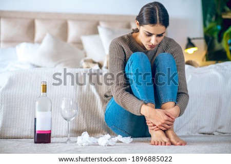 Wine. Young woman feeling depressed and drinking alcohol