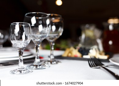 Wineglass and other cutlery on the festive table of restaraunt