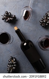 Wineglasses With Red Wine,black Grape And Lying Bottle On Black Stone Desk. Top View.