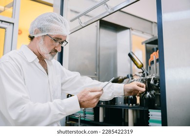 Winemaker professional standard officer work chek hygiene quality of beverage production in line drink factory - Powered by Shutterstock