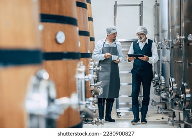 Winemaker working in modern large winery factory liquor drink industry quality and fermentation monitor 
