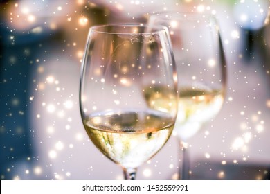 Winery, Fine Dining Drink And Luxury New Years Eve Celebration Concept - Winter Holiday Glasses Of White Wine And Glowing Snow On Background, Christmas Time Romance