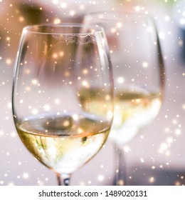 Winery, Fine Dining Drink And Luxury New Years Eve Celebration Concept - Winter Holiday Glasses Of White Wine And Glowing Snow On Background, Christmas Time Romance