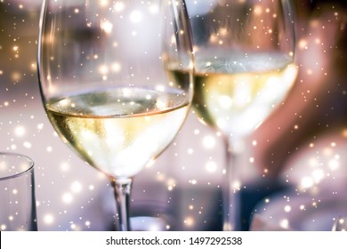 Winery, Fine Dining Drink And Luxury New Years Eve Celebration Concept - Winter Holiday Glasses Of White Wine And Glowing Snow On Background, Christmas Time Romance