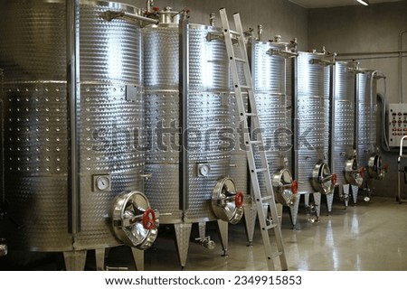 Winery producing wine. Wine fermentation tanks.
