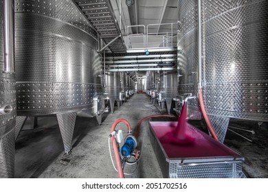 Winery producing wine, Grape ju in tank. Wine fermentation tanks. Wine fermentation process Red grapes in fermentation tank. Pouring wine from a tank.