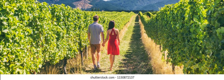 Winery Vineyard Tourists Couple Walking On Wine Farm Tour On Travel Vacation. Wine Tasting Holiday Panoramic Banner.