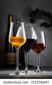 Wines assortment. Red, white, rose wine in glasses and bottles on gray table background. Wine bar, shop, tasting concept - Shutterstock ID 2113743437