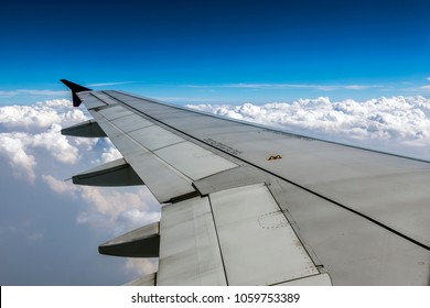 Plane’s Wing Above The Clouds  View From A Plane's Window With Text 