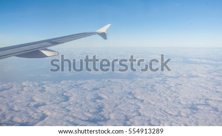 wing of airplane on the sky with clouds