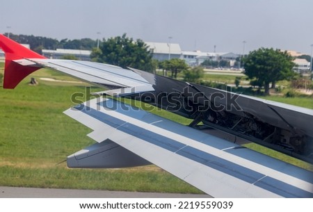 Wing braking of the aircraft on the runway. The wing of an aircraft  open flaps on the wing for is landing. 