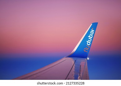 Wing of the FlyDubai airplane during a flight. Winglet of an airliner against the background of the dawn sky. 27.01.2022 Dubai