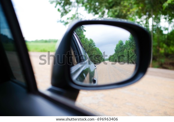 wing mirror of\
black car. See the way\
passed.