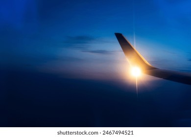 Wing at sunset through the window - Powered by Shutterstock