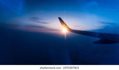 Wing at sunset through the window