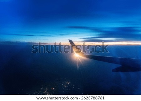 Wing at sunset through the window
