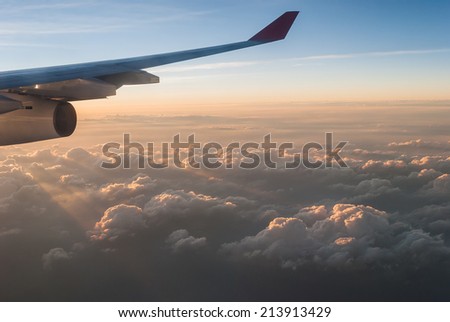 wings of airplane in the sky with cloud