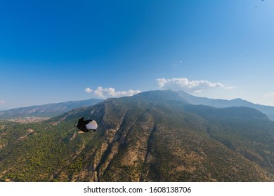 Wingsuit Flyer BASE Jumping In The Mountains