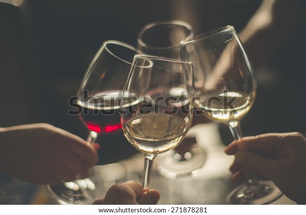 Wining with friends\
Four friends\
cheering\
Drinking wine in a\
restaurant