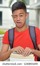 Winking College Filipino Male Student With Books